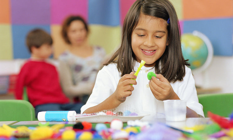 Child making a craft for Holy Spirit crafts for kids.
