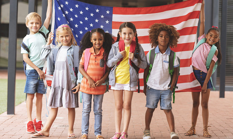 Kids in front of American Flag for 4th of July Minute-to-Win-It Games