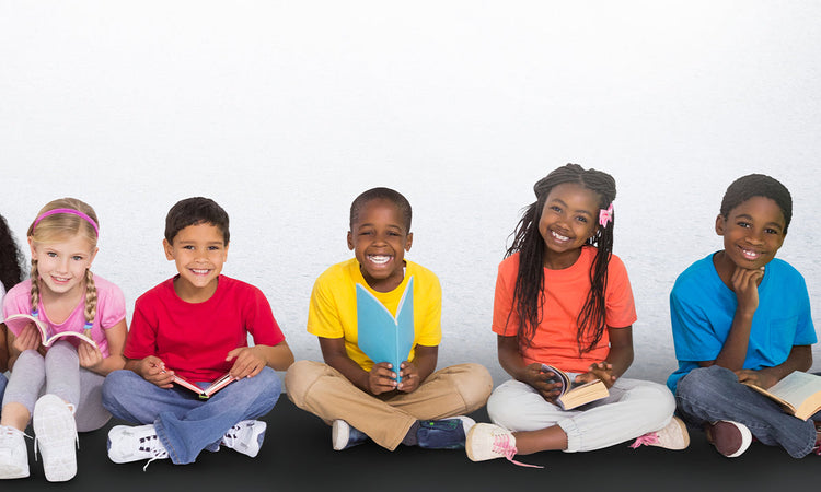 Five kids sit cross-legged holding books and smiling.